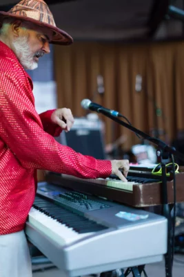 Glenn Tucker performing on keyboards as Gravybrain plays for Friday Night Concerts.