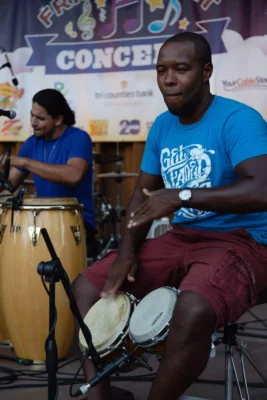 Hand drummer performing with Los Papi Chulos at Friday Night Concerts, 2014.